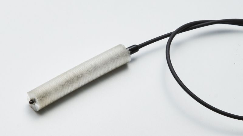 Coriolis-type flowmeter cleaning brushes